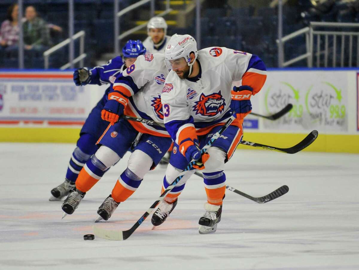 Stephen Gionta (13) of the Bridgeport Sound Tigers brings the puck up ice during a game against the Syracuse Crunch at the Webster Bank Arena on December 17, 2016 in Bridgeport, Connecticut.