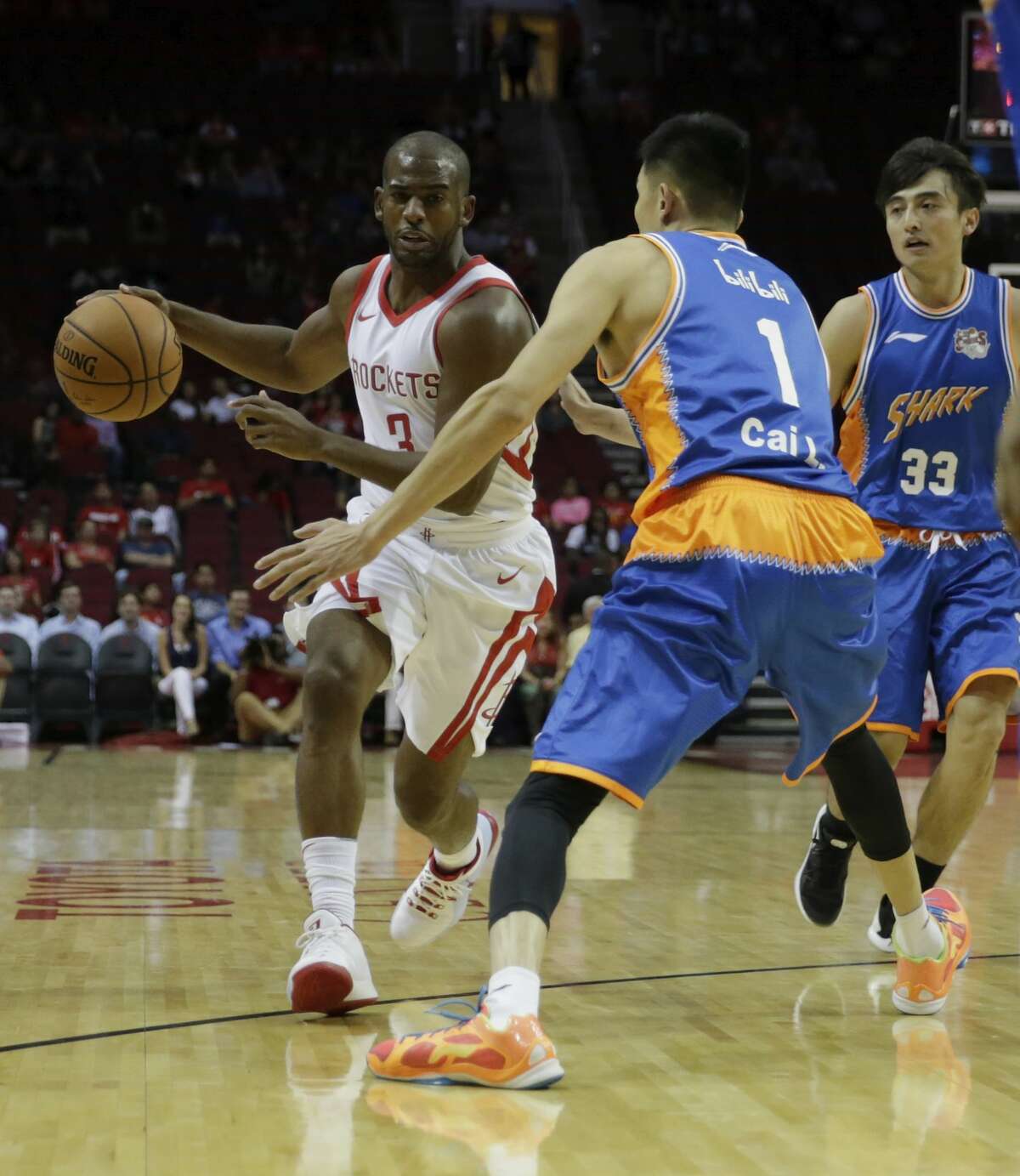 HOUSTON, TX - OCTOBER 05: Chris Paul #3 of Houston Rockets drives the ball in the first quarter defended by Cai Liang #1 of Shanghai Sharks at Toyota Center on October 5, 2017 in Houston, Texas. NOTE TO USER: User expressly acknowledges and agrees that, by downloading and or using this Photograph, user is consenting to the terms and conditions of the Getty Images License Agreement. (Photo by Tim Warner/Getty Images)