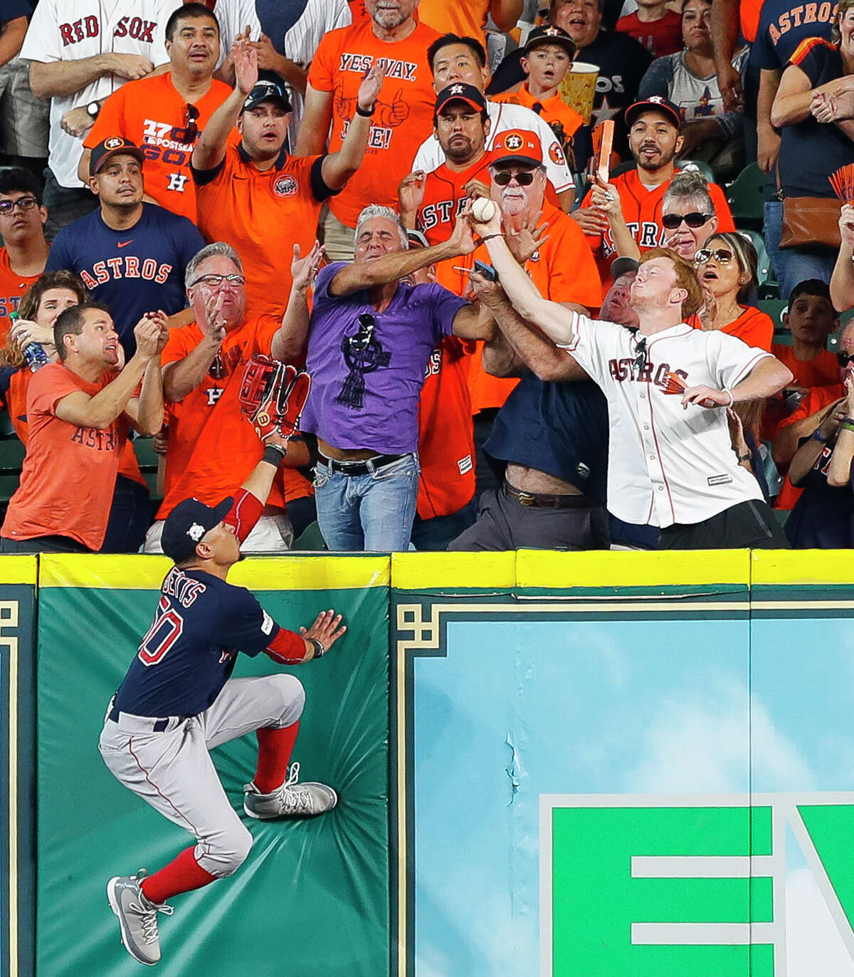 Boston Red Sox right fielder Mookie Betts (50) can't reach a third inning home run by Houston Astros center fielder George Springer (4) during Game 2 of the ALDS at Minute Maid Park on Friday, Oct. 6, 2017, in Houston.