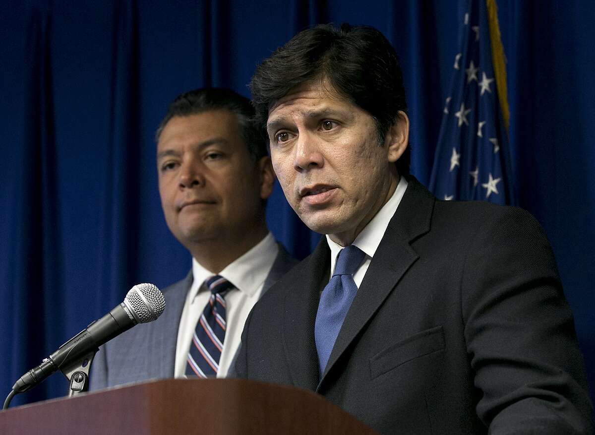 FILE -- In this Sept. 5, 2017 file photo, State Senate President Pro Tem Kevin de Leon, D-Los Angeles, right, flanked by Secretary of State Alex Padilla, answers questions at a news conference in Sacramento, Calif. California Gov. Jerry Brown signed de Leon's SB54, the statuary state bill, that extends protections statewide for immigrants living the United State illegally, Thursday, Oct. 5, 2017. (AP Photo/Rich Pedroncelli, file)