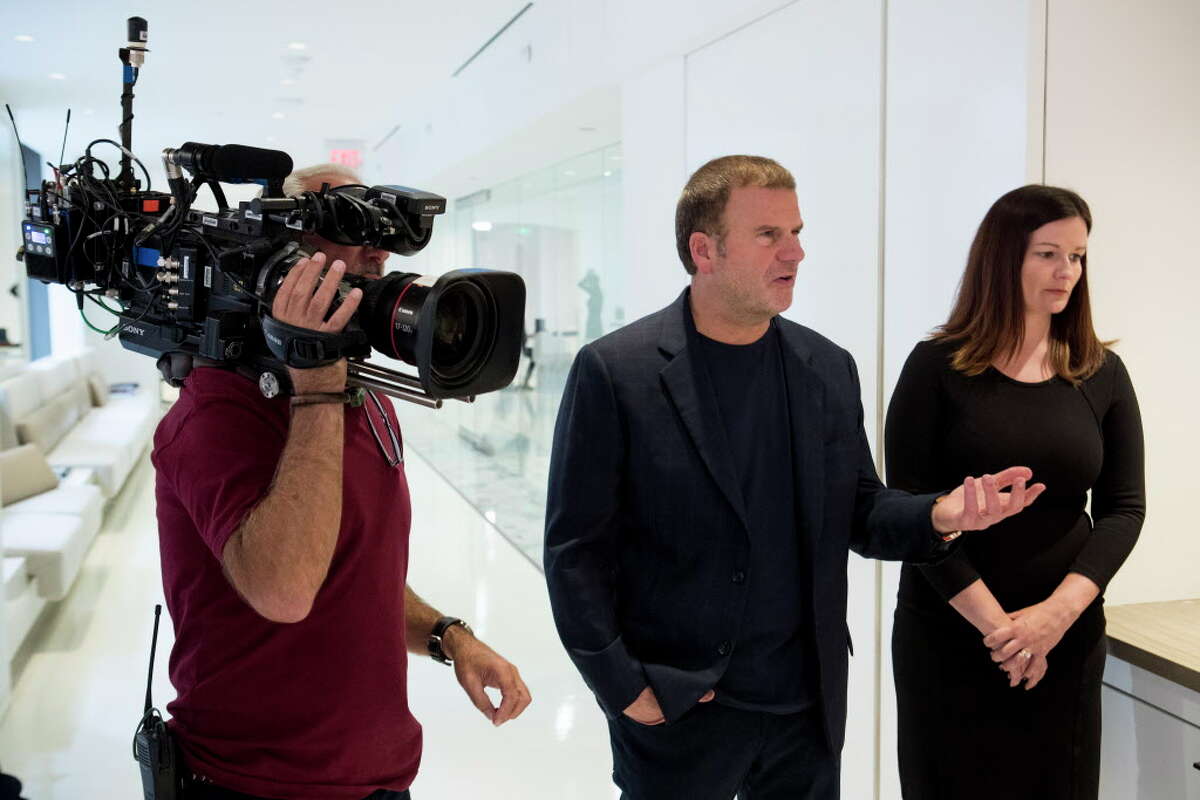 BILLION DOLLAR BUYER (2016 - 2018) Tilman Fertitta, left, and Kerri Carr work on a scene during a taping of Billion Dollar Buyer at the offices of Dancie Perugini Ware Public Relations on Monday, Oct. 2, 2017, in Houston.