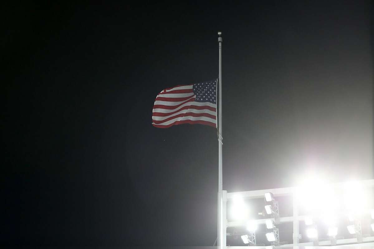 NEW YORK, NY - OCTOBER 03: The flag is flown at half-staff in wake of deadly Las Vegas shooting during the American League Wild Card Game between the Minnesota Twins and the New York Yankees at Yankee Stadium on October 3, 2017 in the Bronx borough of New York City. (Photo by Elsa/Getty Images)