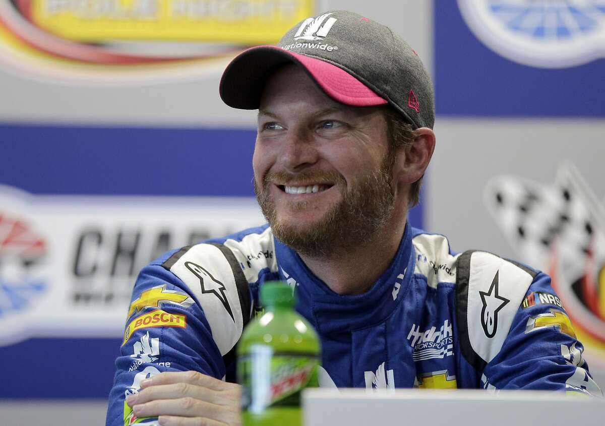 Dale Earnhardt Jr. smiles at members of various sports teams from his former high school during a news conference after practice for Sunday's NASCAR Cup Series auto race at Charlotte Motor Speedway in Concord, N.C., Friday, Oct. 6, 2017. The track donated $100,000 to Carolinas HealthCare Systems for concussion testing and research in Earnhardt's name. (AP Photo/Chuck Burton)