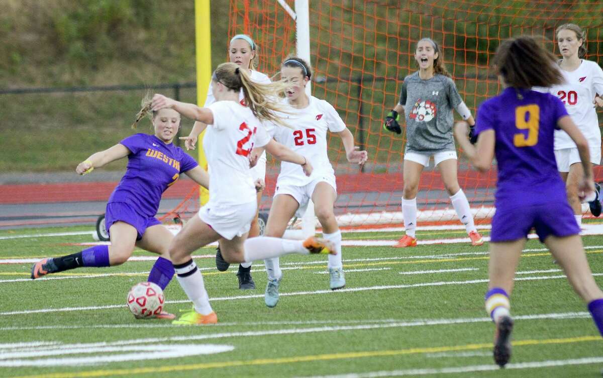Westhill Malina Lasicki (7) attempts to push the ball into the crease on Greenwich Katherine Gallagher (22) in an FCIAC girls soccer game at Cardinal Stadium in Greenwich, Connecticut on Friday, Oct. 6, 2017. Greenwich defeated Westhill 4-3.