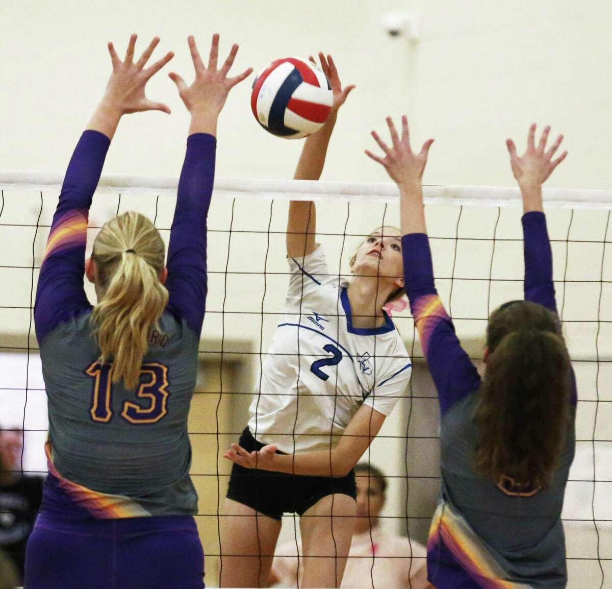 La Vernia's Addison Mulroney (02) gets an opening for a shot against Navarro's Kelly Helms (13) and Allie Benner (05) in girls volleyball in La Vernia on Friday, Oct. 6, 2017. La Vernia won the deciding fifth game for the overall victory. (Kin Man Hui/San Antonio Express-News)