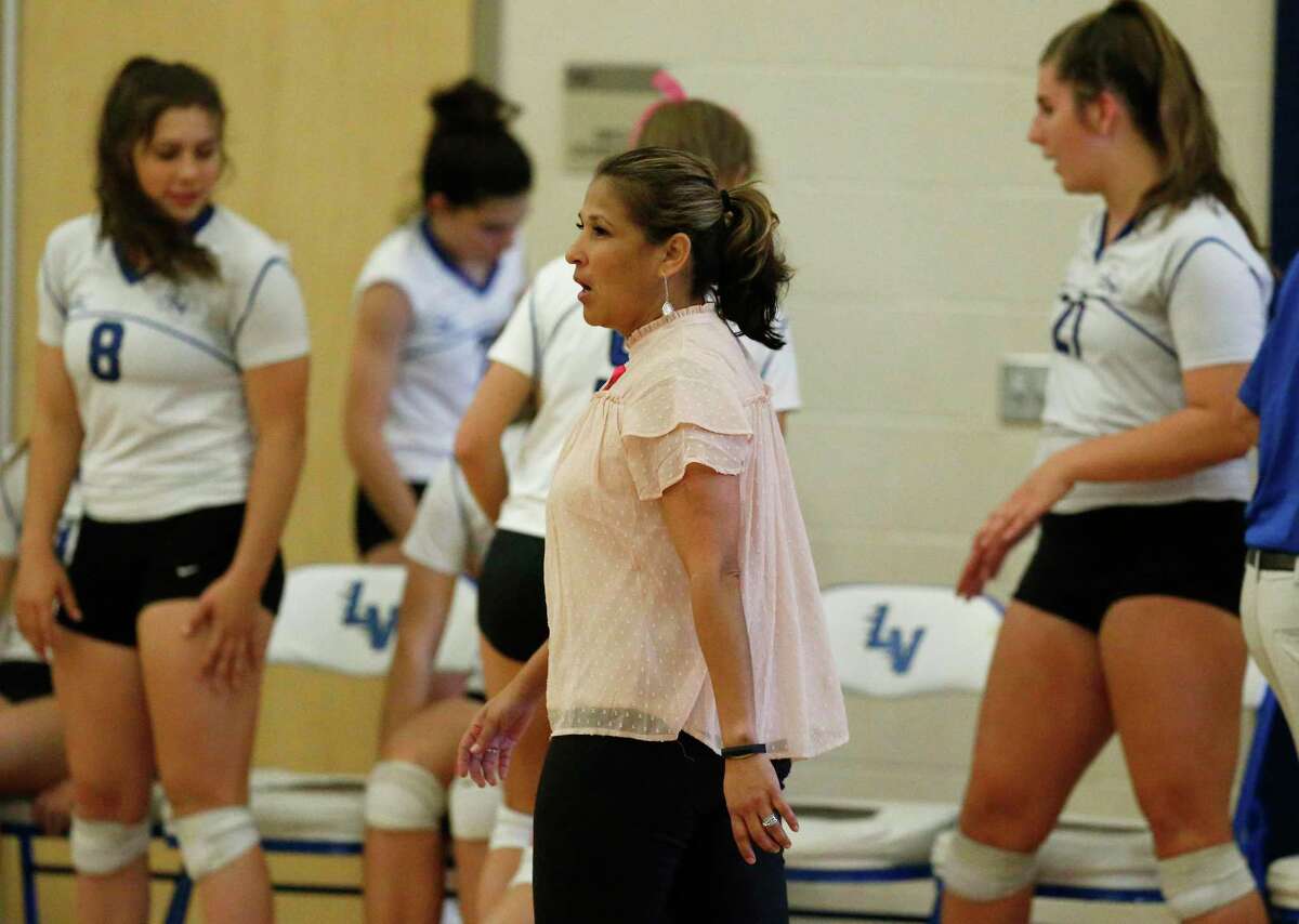 La Vernia volleyball coach Theresa Reyes (center) directs her team against Navarro during their game in La Vernia on Friday, Oct. 6, 2017. La Vernia won the deciding fifth game for the overall victory. (Kin Man Hui/San Antonio Express-News)