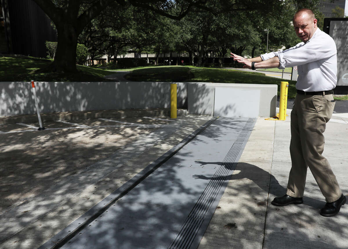 Zane Gifford of Riverview Realty Partners talks about a flood gate that protects 3000 Post Oak. Gifford, the building's chief engineer, recalls when the building had none. "You don't want to go through what we've been through. It's stressful," he says.