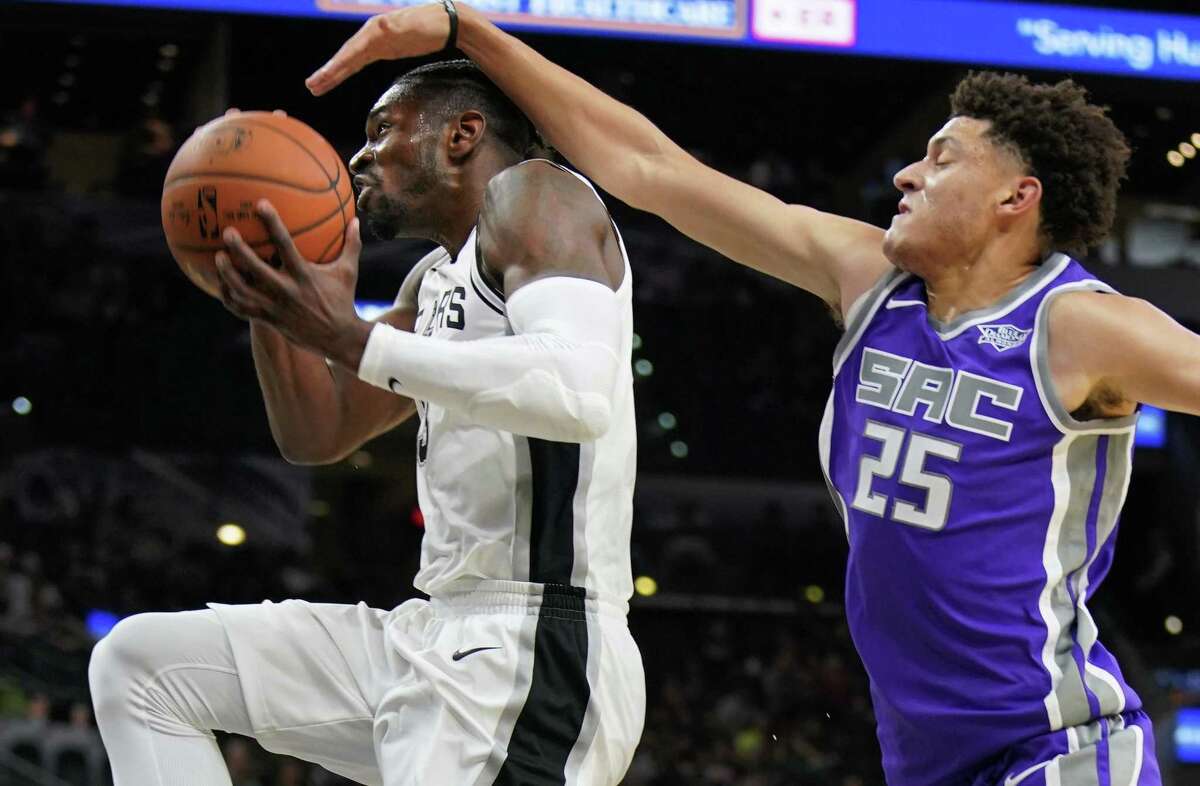 Spurs’ Brandon Paul attempts to shoot as he is defended by the Sacramento Kings’ Justin Jackson during the second half of a preseason game on Oct. 6, 2017, in San Antonio.