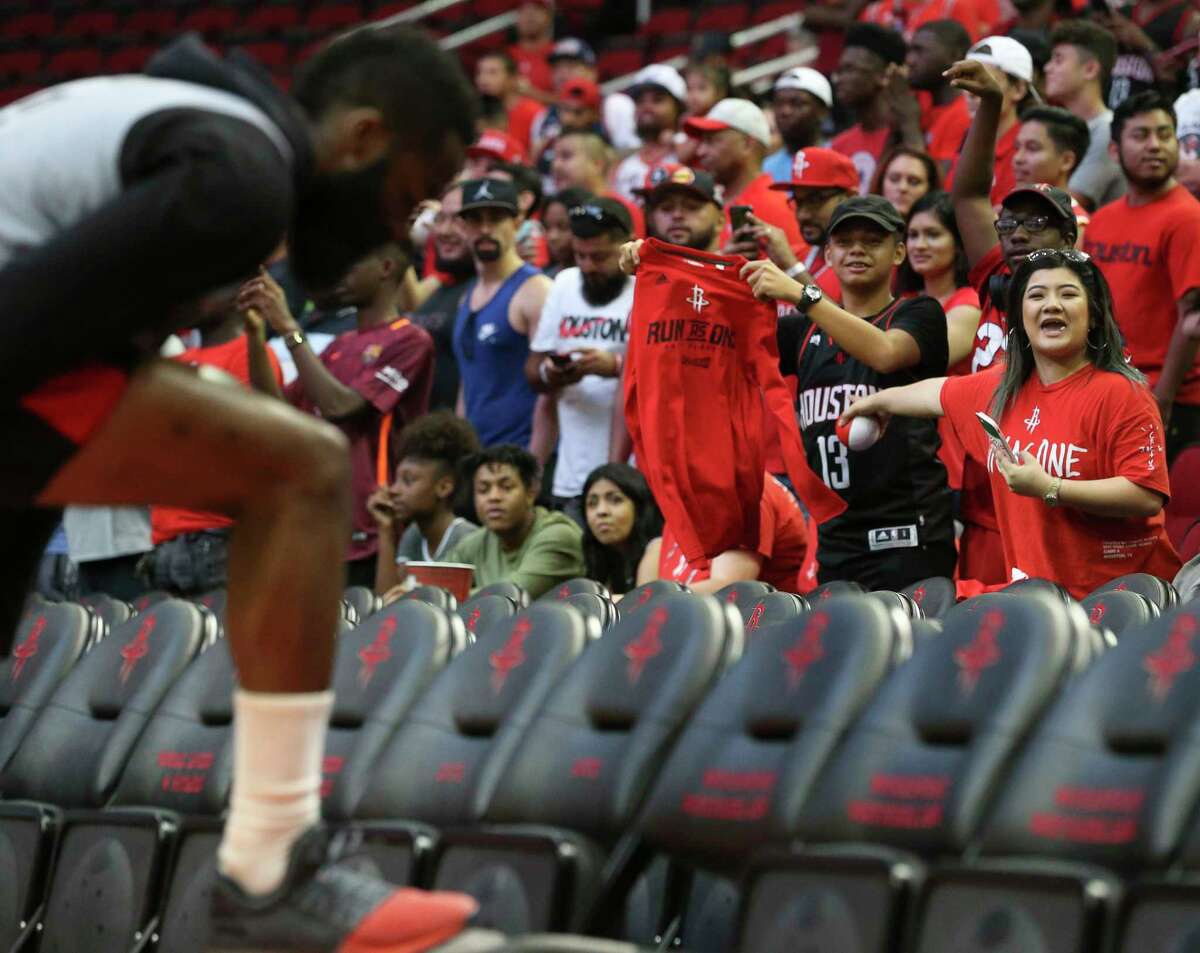 Houston Rockets fans try to get James Harden's attention before the practice game at the fan fest at Toyota Center Saturday, Oct. 7, 2017, in Houston.