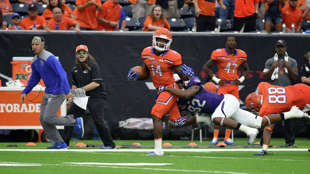 Sam Houston State junior wide receiver Davion Davis (14) tries to break away from Stephen F. Austin defender Jamall Shaw (32) on his reception late in the 2nd quarter of their Battle of the Piney Woods clash at NRG Stadium in Houston on Saturday, Oct. 7, 2017. (Photo by Jerry Baker/Freelance)