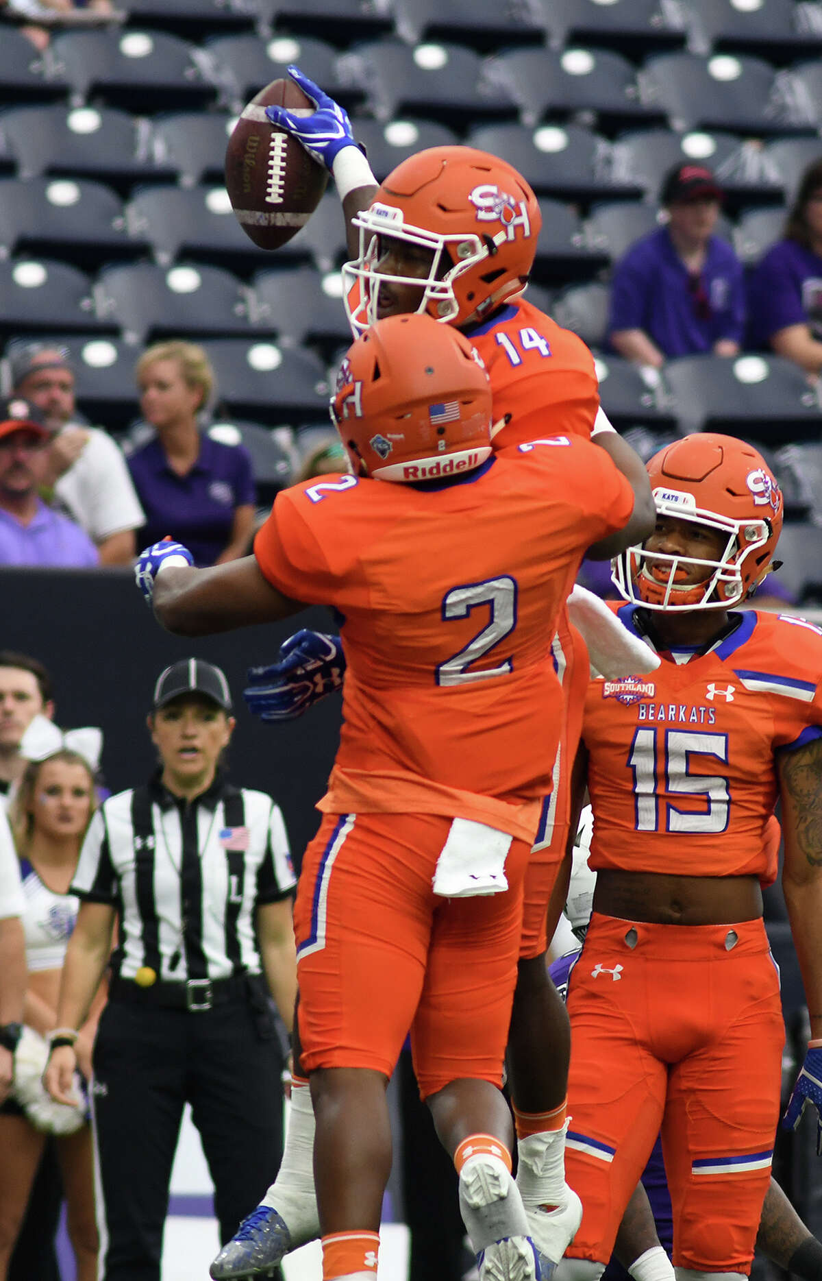 Sam Houston State junior wide receiver Davion Davis (14) celebrates his first quarter touchdown against Stephen F. Austin with teammates Tyler Scott (2) and Coree Compton (15) during their Battle of the Piney Woods clash at NRG Stadium in Houston on Saturday, Oct. 7, 2017. (Photo by Jerry Baker/Freelance)