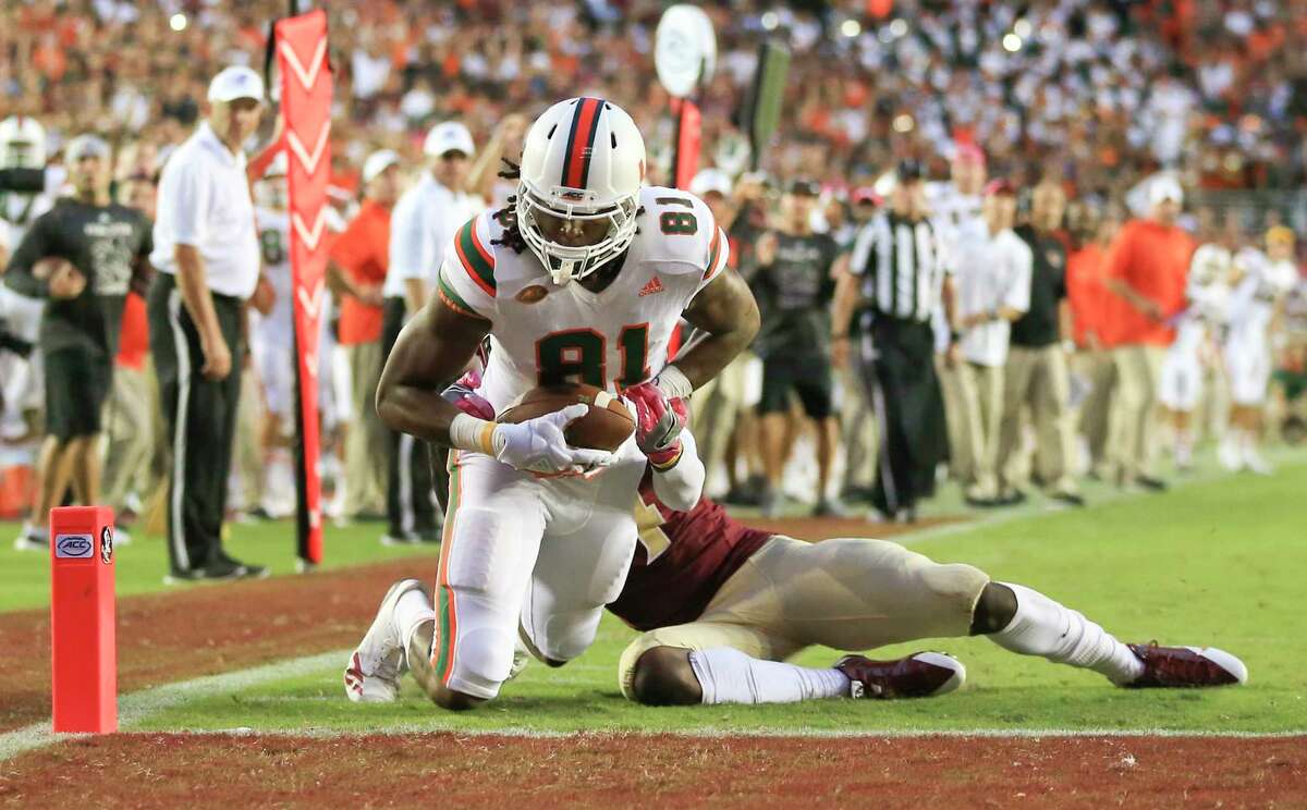 Miami wide receiver Darrell Langham lunges across the goal line on a 23-yard touchdown catch with six seconds remaining to give the 13th-ranked Hurricanes a 24-20 victory over Florida State on Saturday.