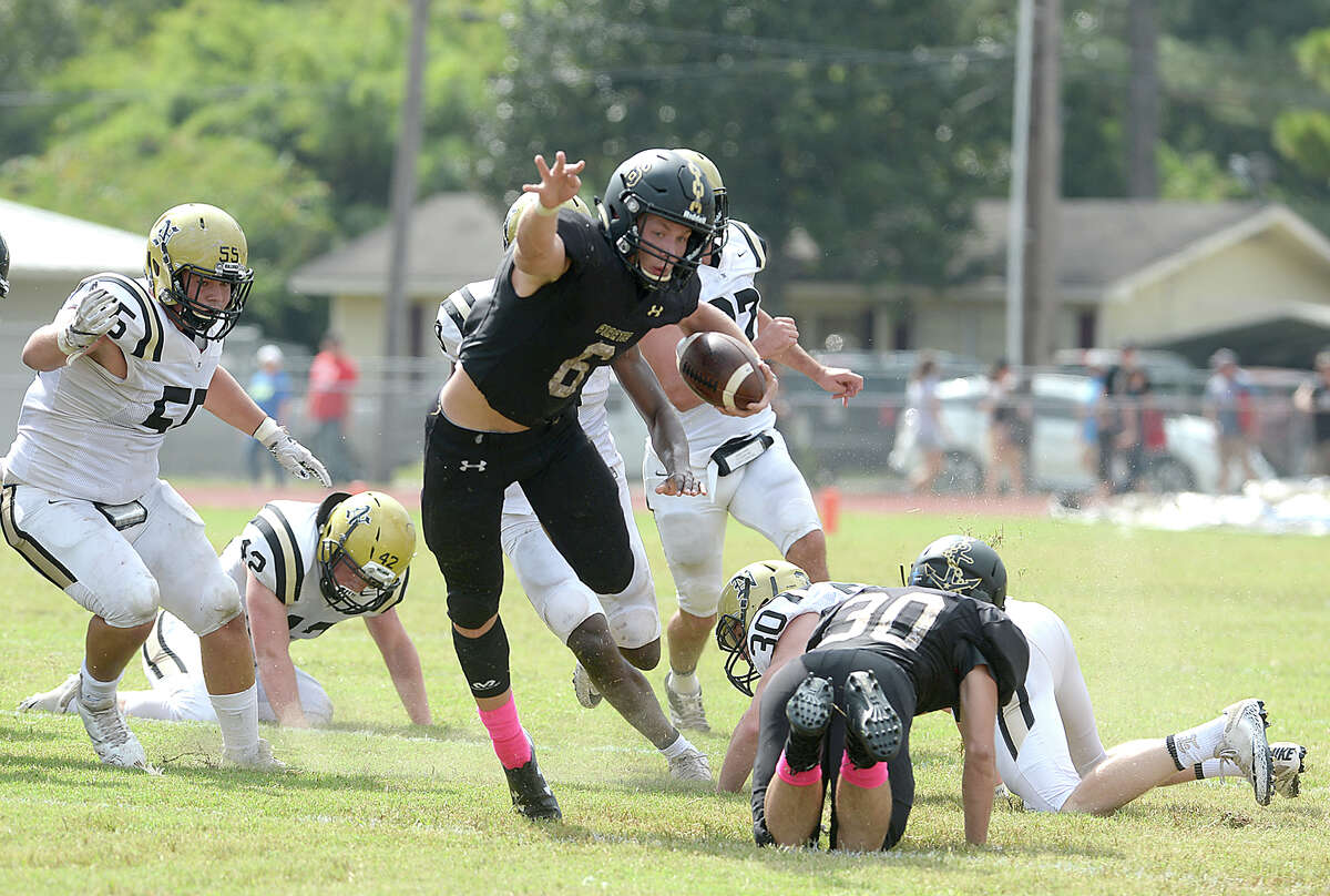 Vidor's William Fawcett leaps over the tackle attempt by Nederland's defense during their match-up Saturday at Vidor High School. Photo taken Saturday, October 7, 2017 Kim Brent/The Enterprise