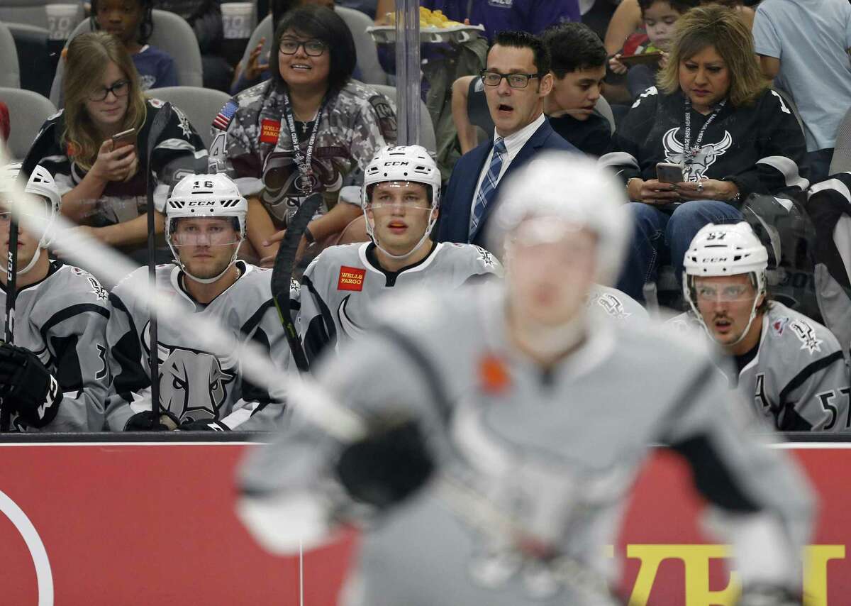 San Antonio Rampage's head coach Eric Veilleux (center rear) and players watch first period action against the Ontario Reign from the bench Saturday Oct. 7, 2017 at the AT&T Center.