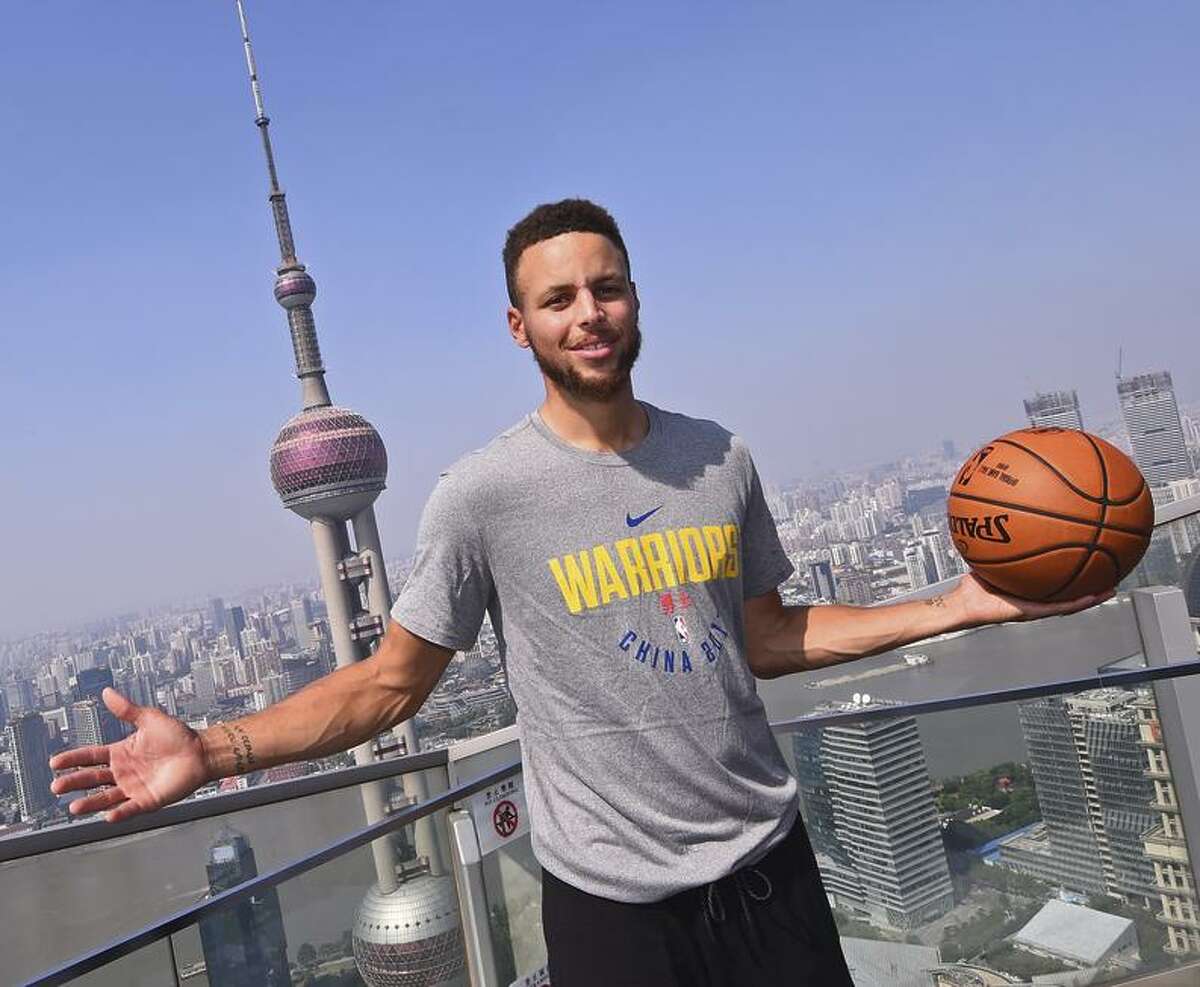Clockwise, from top left: Klay Thompson boards a plane for China last Sunday; Kevin Durant addresses media at practice; Stephen Curry poses in Shanghai; and Nick Young plays in an “NBA2K”-sponsored event.