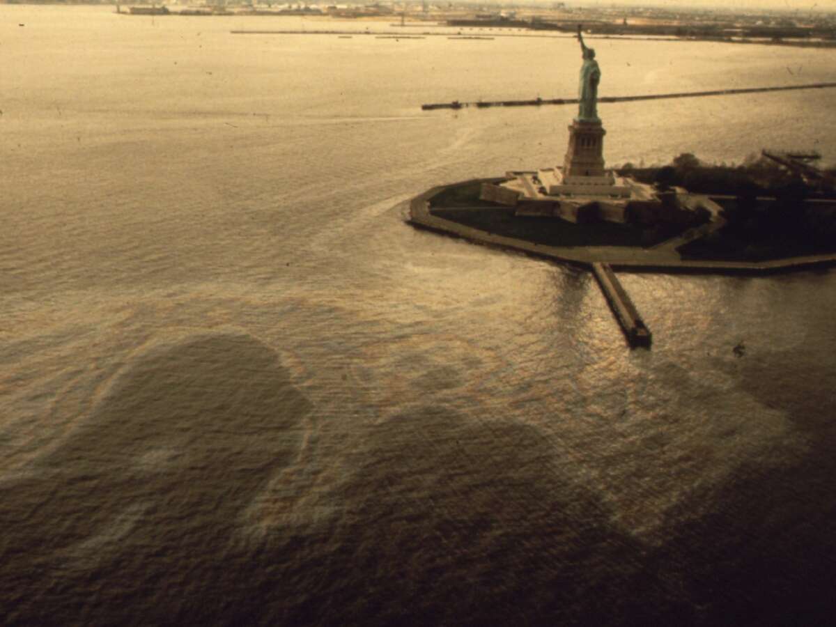 An oil slick surrounding the Statue of Liberty. The photo comes from the EPA's 'Documerica' series, documenting pollution in America from the late 1960s to the end of the 1970s.