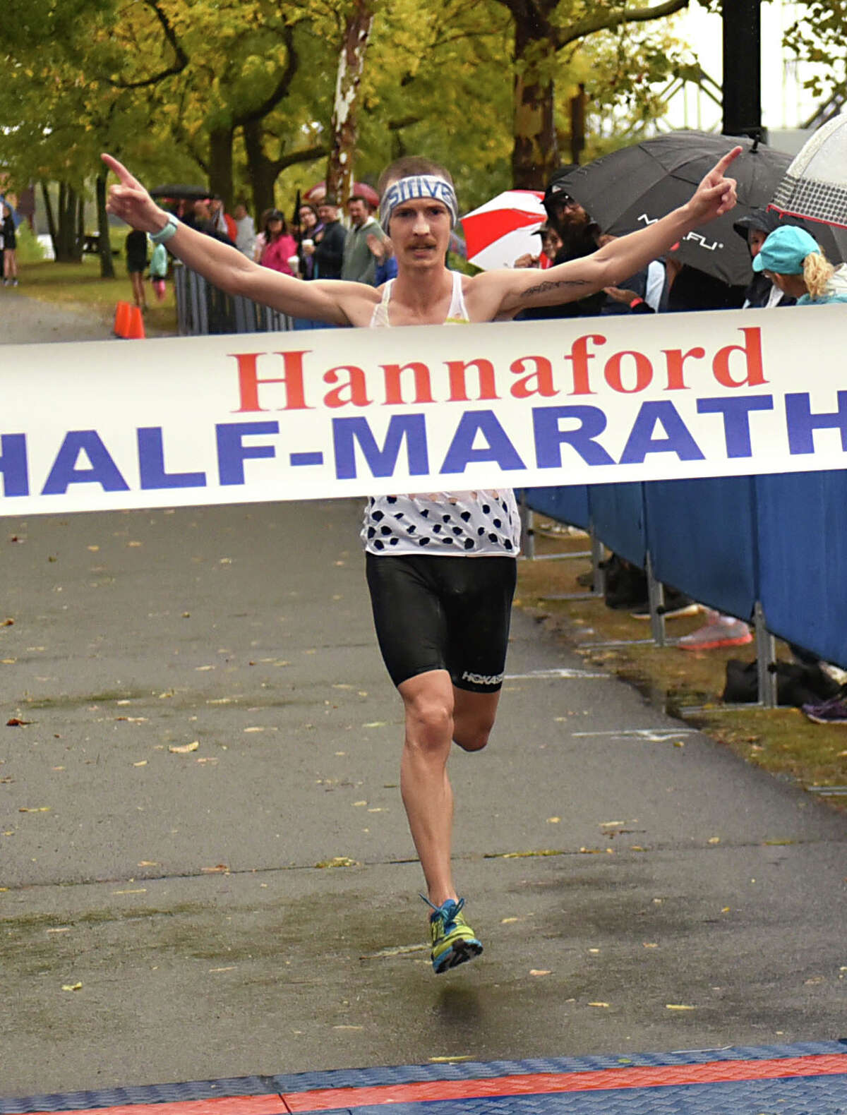 Tyler Andrews of Arlington, VA makes his way across the finish line as the men's Hannaford Half-Marathon winner at 1:07:33 at the Corning Preserve on Sunday, Oct. 8, 2017 in Albany, N.Y. The half marathon runners started at Colonie Town Park in Cohoes. (Lori Van Buren / Times Union)