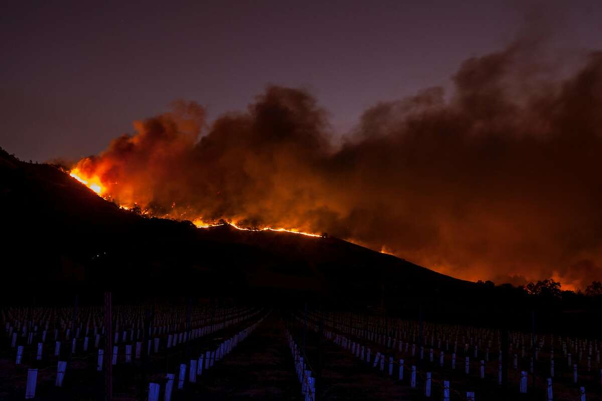 Flames moved through the hills above the Silverado Trail as a fast moving wind-whipped-wild fire raged though the Napa/Sonoma wine region in Napa on Oct. 9, 2017. Multiple fire that erupted in Napa, Sonoma, Calistoga and the Santa Rosa area have burned homes and wineries. Mandatory evacuations have be displaced hundreds of residents through out the area.