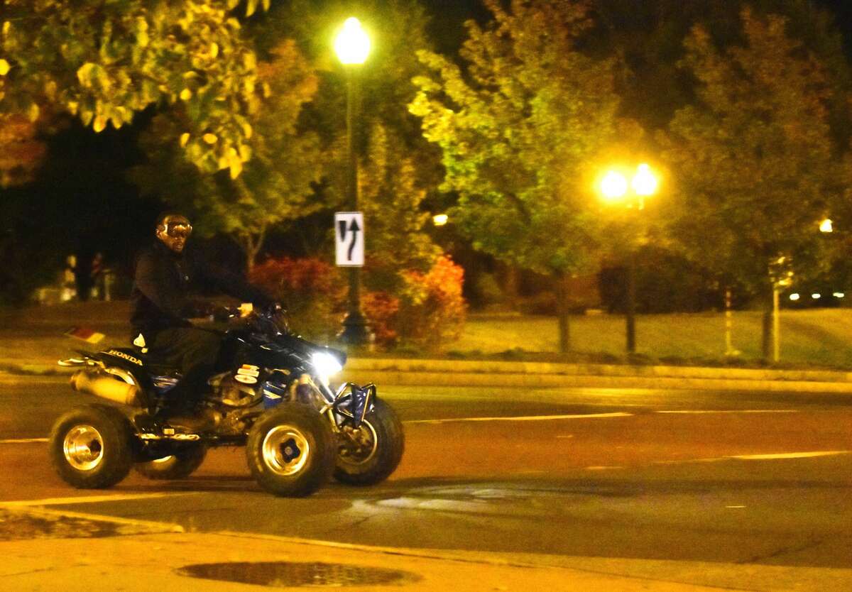 A man rides an all-terrain vehicle near the Palace Theatre in downtown Albany on Sunday. Police in Albany say people riding non-licensed off-road vehicles on city streets is a problem that has ebbed and flowed over the years.