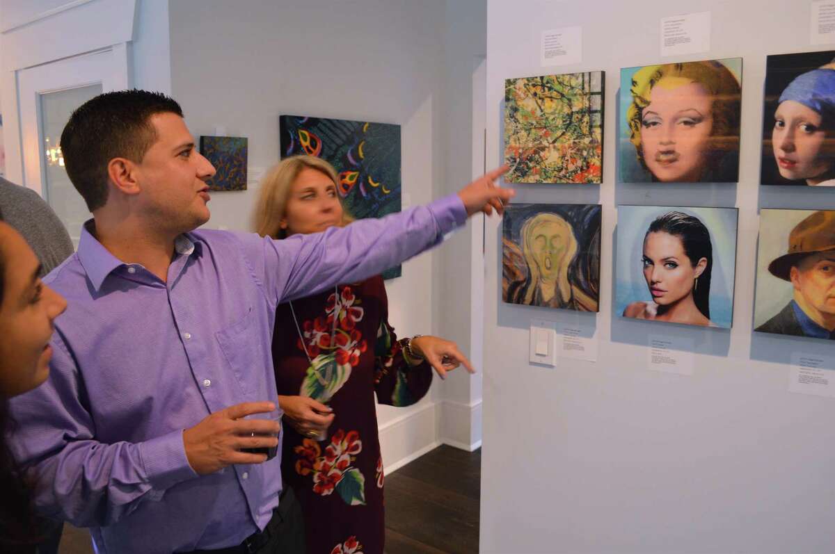 Alex Dacosta of Shelton admires some artwork at the open house and art sale at 5 Ridgewood Lane, Saturday, Oct. 7, 2017, in Westport, Conn.