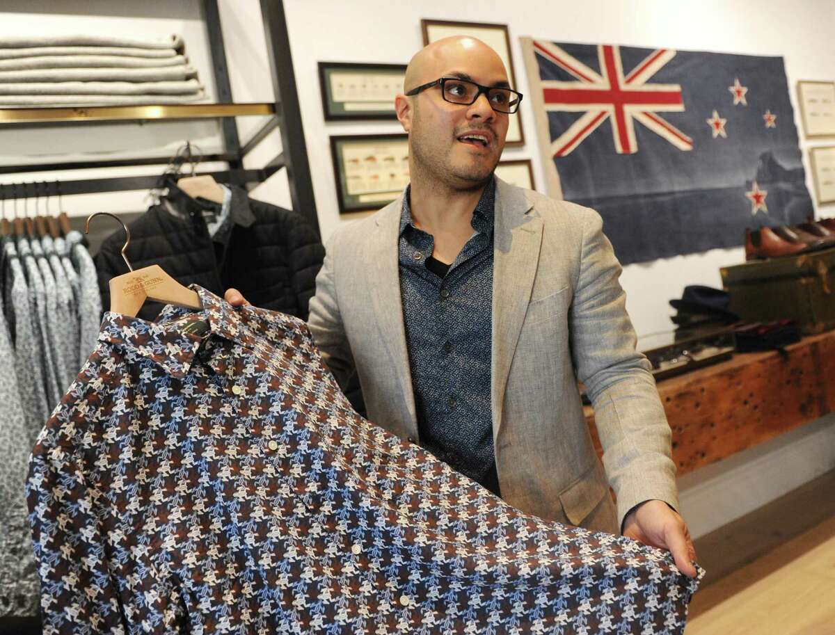 Store manager Marc Marranzino shows the pattern of a Liberty shirt, custom-designed for Rodd & Gunn, at the New Zealand-based men's clothing store Rodd & Gunn along Greenwich Avenue in Greenwich, Conn. Wednesday, Oct. 4, 2017.