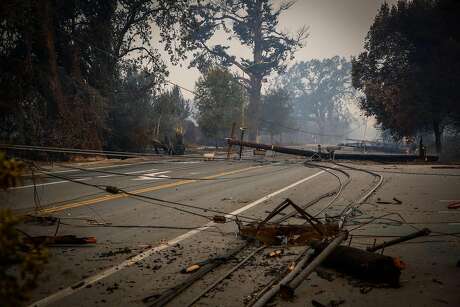 Power lines are seen on Old Redwood Highway after the Tubbs fire tore through the area in Santa Rosa, Calif., on Monday, Oct. 9, 2017.