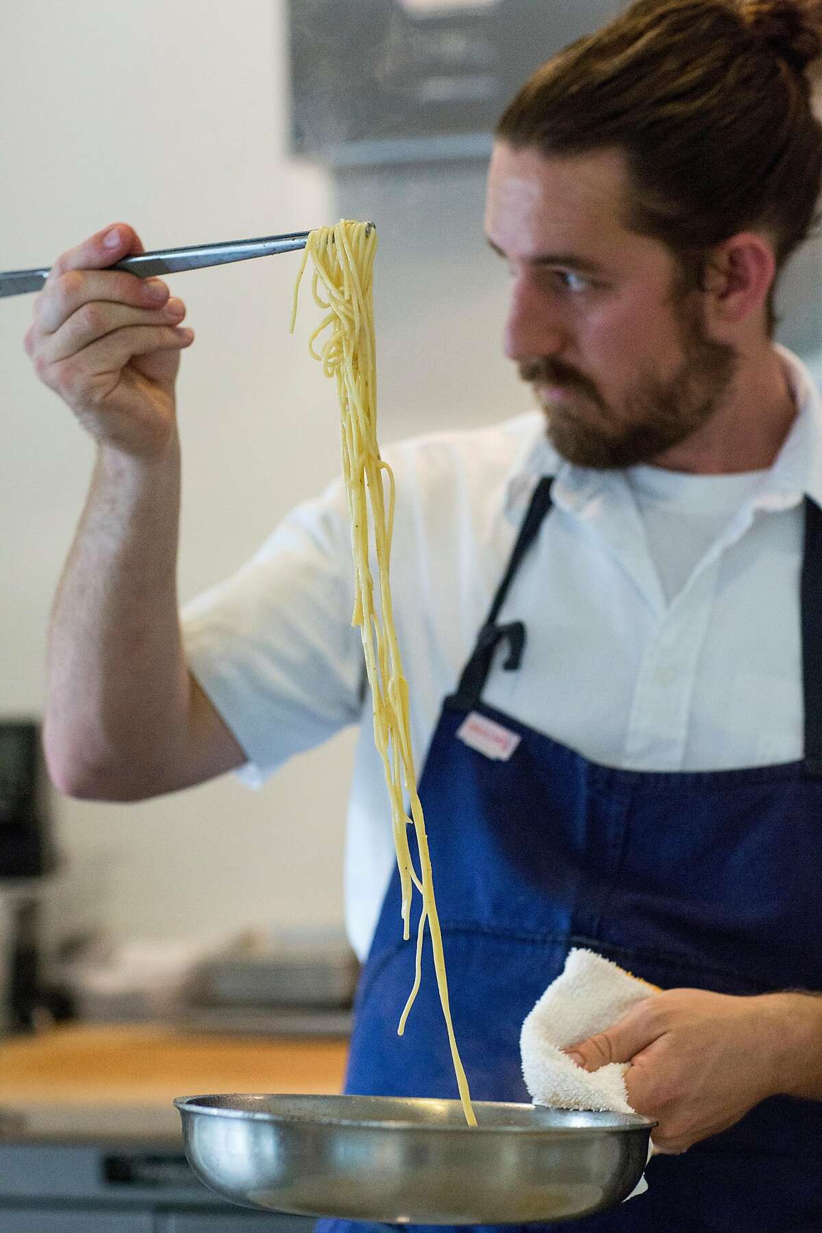 Michael Warring works on cooking a noodle dish with fairytale eggplant, guanciale, patron peppers and black truffle, which was served as the third course at his restaurant Michael Warring in Vallejo, Calif., on Sunday, October 1, 2017. The restaurant offers a six course tasting menu with the option for wine or beer pairings.