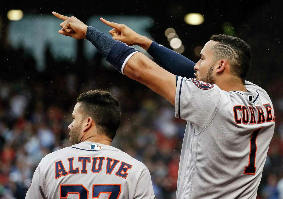 Houston Astros shortstop Carlos Correa (1) points to pinch hitter Carlos Beltran after Beltran hit an RBI double against the Boston Red Sox during the ninth inning of Game 4 of the ALDS at Fenway Park on Monday, Oct. 9, 2017, in Boston.