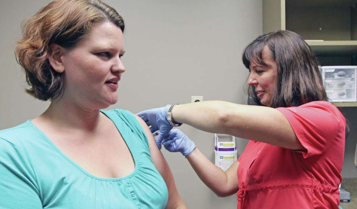FILE - A pregnant woman gets her flu shot. The number of cases in Texas is on the rise.
