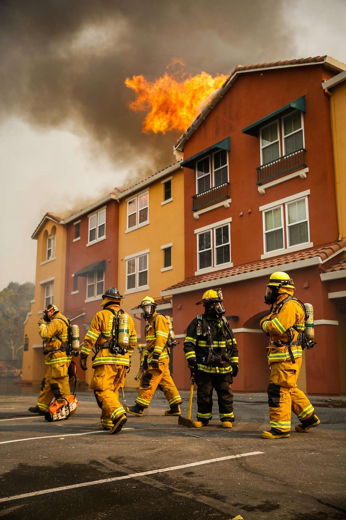 Firefighters work to contain the Tubbs fire at the Overlook apartment complex off of Bicentennial Way in Santa Rosa, Calif., on Monday, Oct. 9, 2017.