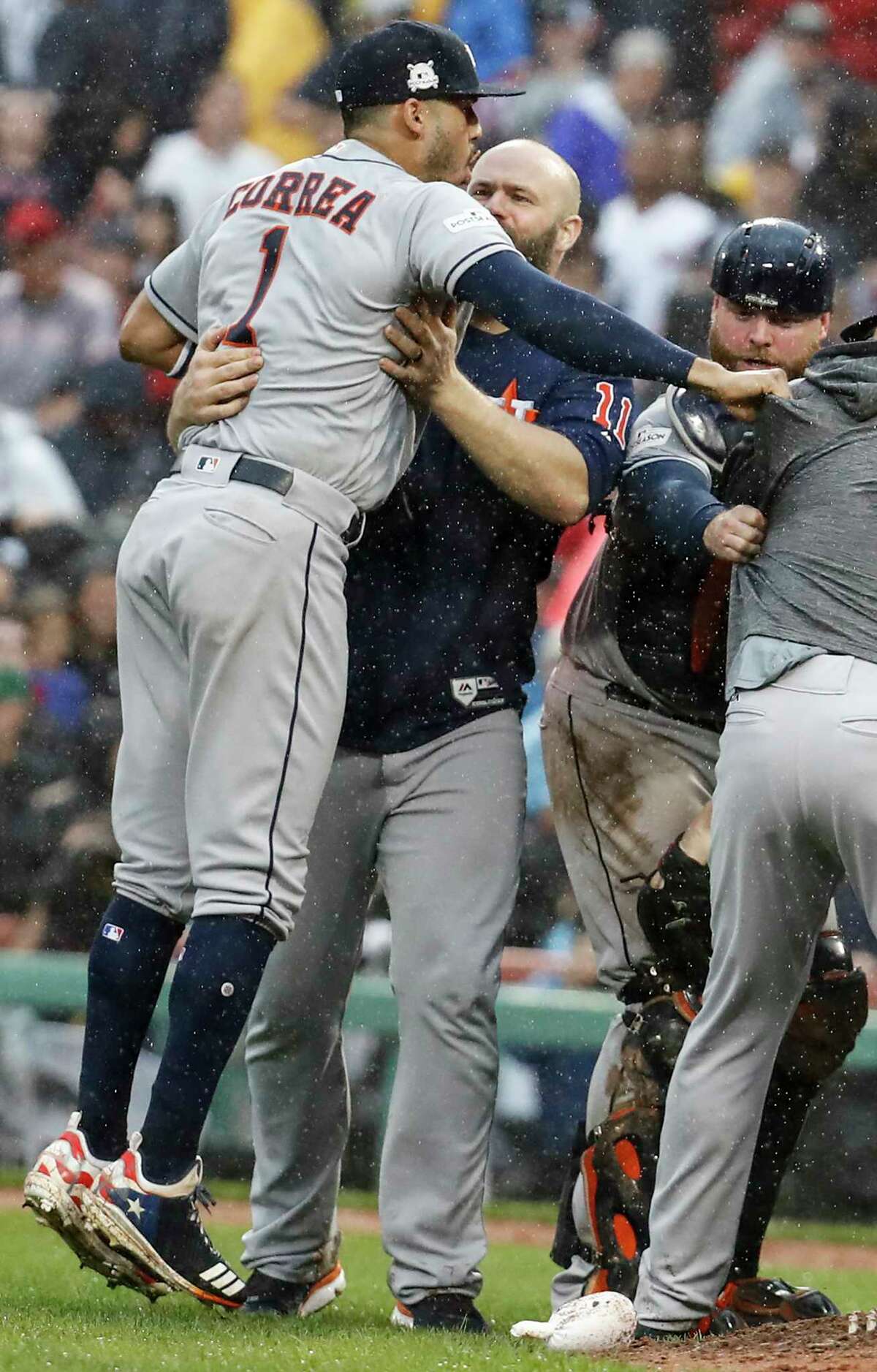 Houston Astros shortstop Carlos Correa (1), designated hitter Evan Gattis (11) and catcher Brian McCann (16) celebrate the Astros 5-4 win over the Boston Red Sox in Game of the ALDS at Fenway Park on Monday, Oct. 9, 2017, in Boston. The Astros won the series 3-1.