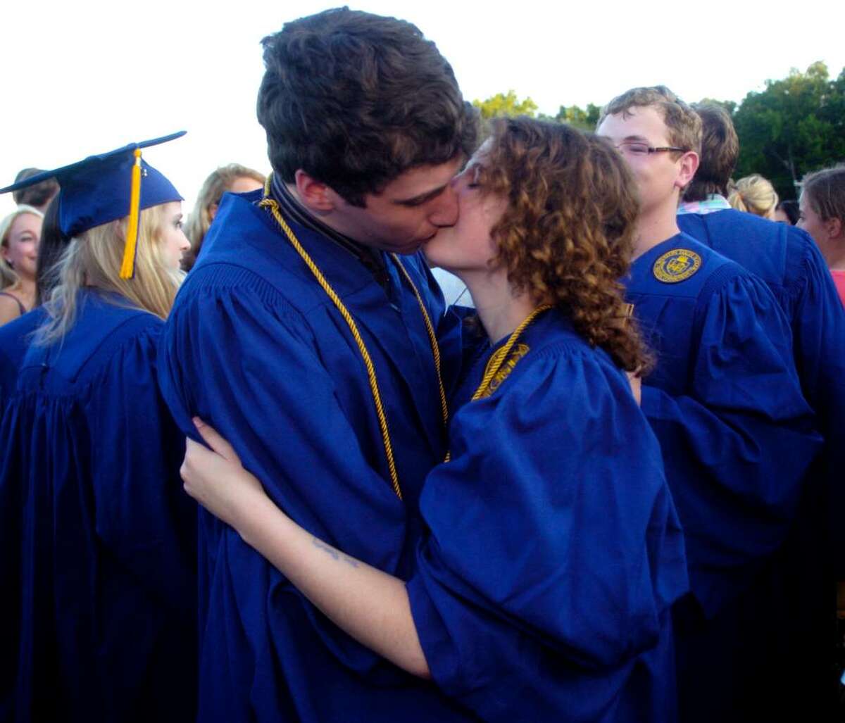 Salutatorian Aaron Kabcenell and graduate Jenny Horowitz exchange a kiss after the Weston High School graduation ceremony at the school on Thursday, June 24, 2010.