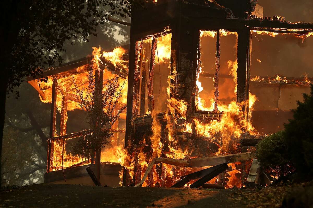 Flames consume a home as an out of control wildfire move through the area on Oct. 9, 2017 in Glen Ellen, Calif. Tens of thousands of acres and dozens of homes and businesses have burned in widespread wildfires that are burning in Napa and Sonoma counties.