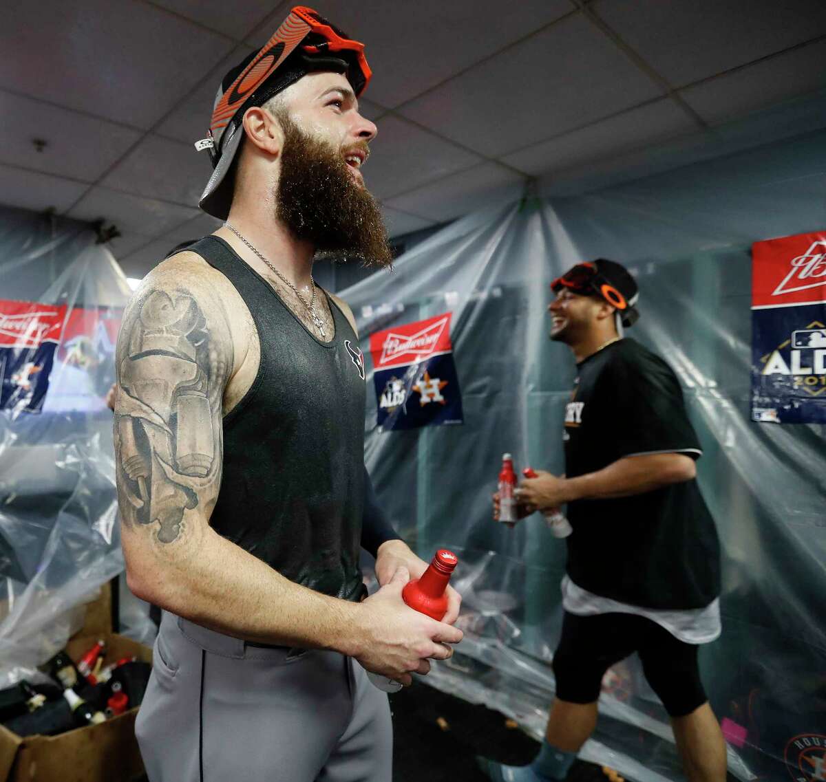 Houston Astros pitcher Dallas Keuchel celebrates in the clubhouse after the Astros beat Boston Red Sox 5-4 in the ALDS Game 4 at Fenway Park, Monday, Oct. 9, 2017, in Boston .