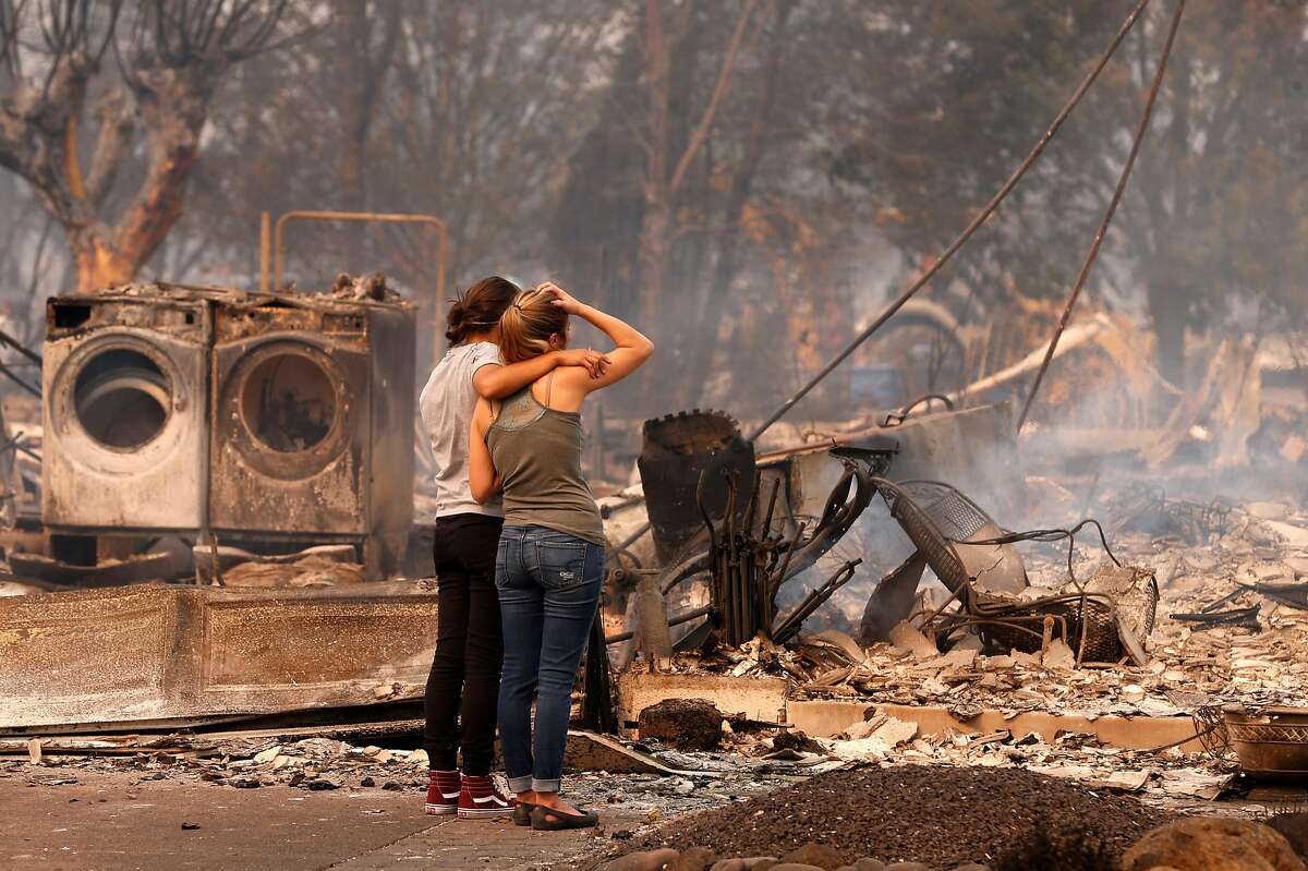 Steph Gediman, (left) comforts Brandi Burns in front of Burns' destroyed at the scene of the Tubbs Fire in Santa Rosa, Ca., on Monday October 9, 2017. Massive wildfires ripped through Napa and Sonoma counties early Monday, destroying hundreds of homes and businesses on Monday October 9, 2017