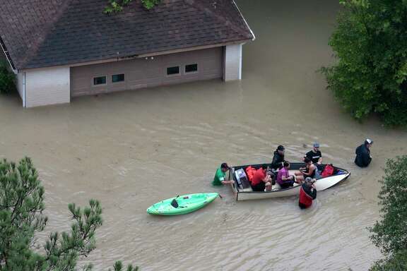 Flood victims are evacuated by boat from their neighborhood near the Addicks Reservoir as floodwaters rise from Tropical Storm Harvey on Tuesday, Aug. 29, 2017, in Houston. ( Brett Coomer / Houston Chronicle )