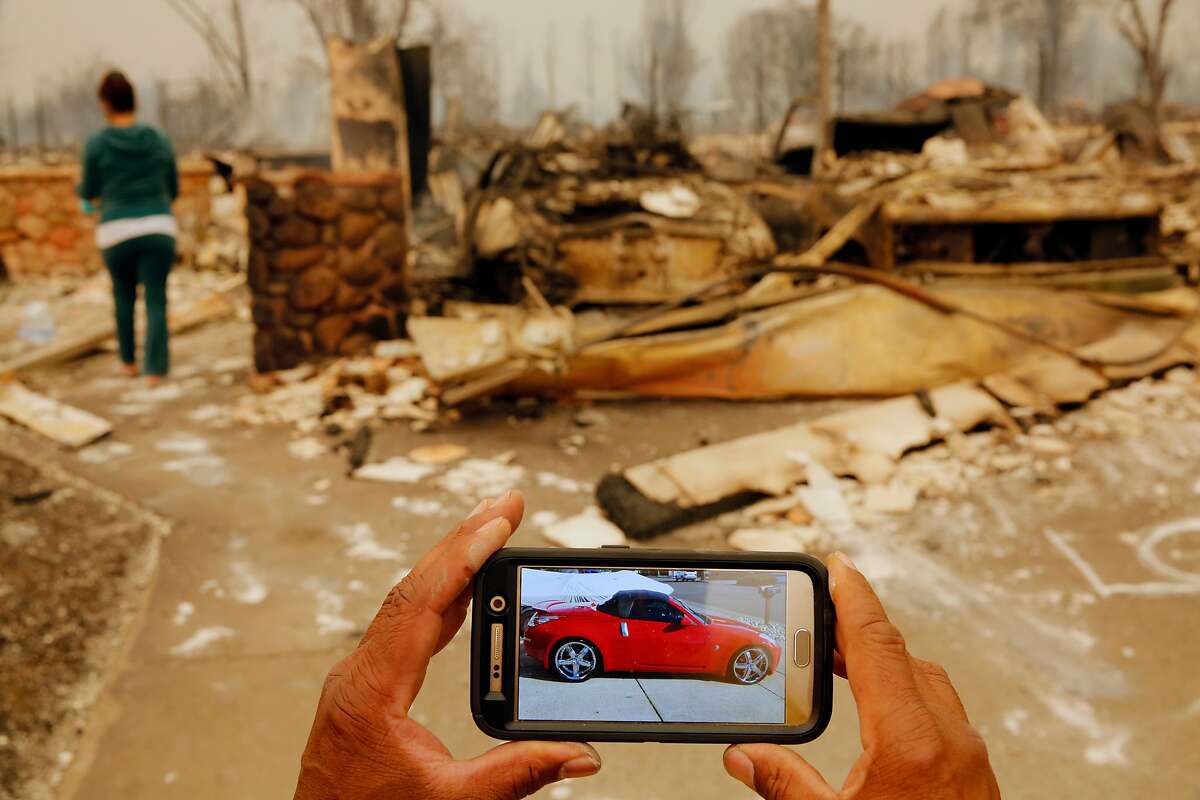 Keith Norris shows what his car destroyed in the fire looked like before the fire, in Santa Rosa, Ca., on Monday October 9, 2017. Massive wildfires ripped through Napa and Sonoma counties early Monday, destroying hundreds of homes and businesses.