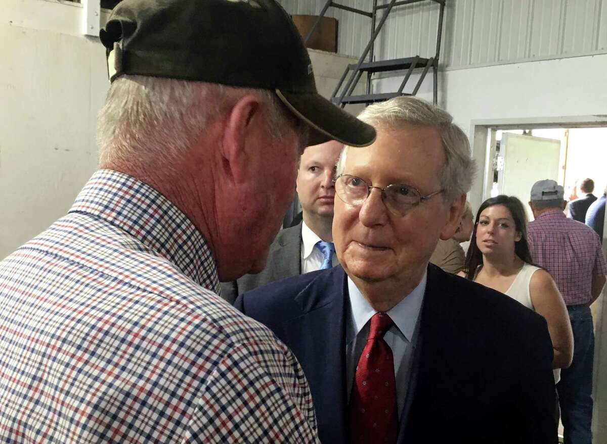 CORRECTS LAST NAME OF FARMER TO BACH - Senate Majority Leader Mitch McConnell of Ky., talks to Kentucky farmer Mike Bach at Mahan Farms in Paris, Ky, Monday, Oct. 9, 2017. Sen. Bob Corker is hardly the only Republican lambasting Donald Trump and raising dark concerns about harm the president might cause the U.S. and the world - he just the only one doing do in public. McConnell who?’s also been the target of Trump?’s attacks after the Senate?’s failure to pass health care legislation, didn?’t directly answer when asked at an event in Hazard, Kentucky, whether he shared Corker?’s sentiments. (AP Photo/Adam Beam) ORG XMIT: KYAB102