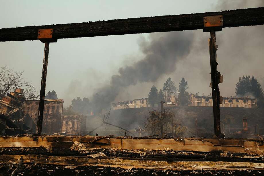 The Hilton Sonoma Wine Country is framed between the destroyed beams of Fountaingrove Inn's in Santa Rosa, Calif., Monday, Oct. 9, 2017. Photo: Mason Trinca, Special To The Chronicle
