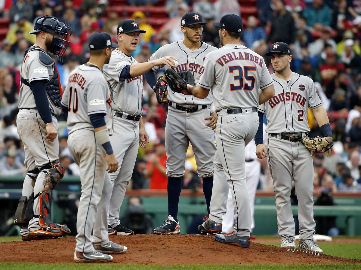 Houston Astros manager A.J. Hinch, third from left, gives the ball to pitcher Justin Verlander (35) for his very first Major League relief appearance during the fifth inning in Game 4 of baseball's American League Division Series against the Boston Red Sox, Monday, Oct. 9, 2017, in Boston. (AP Photo/Michael Dwyer)