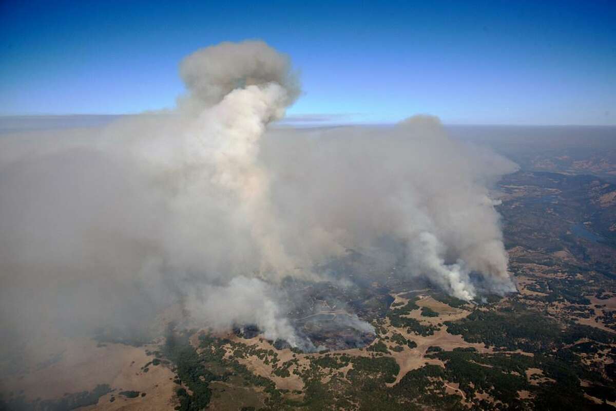 Smoke rises as a wildfire burns in the hills east of Napa, Calif., Monday, Oct. 9, 2017.
