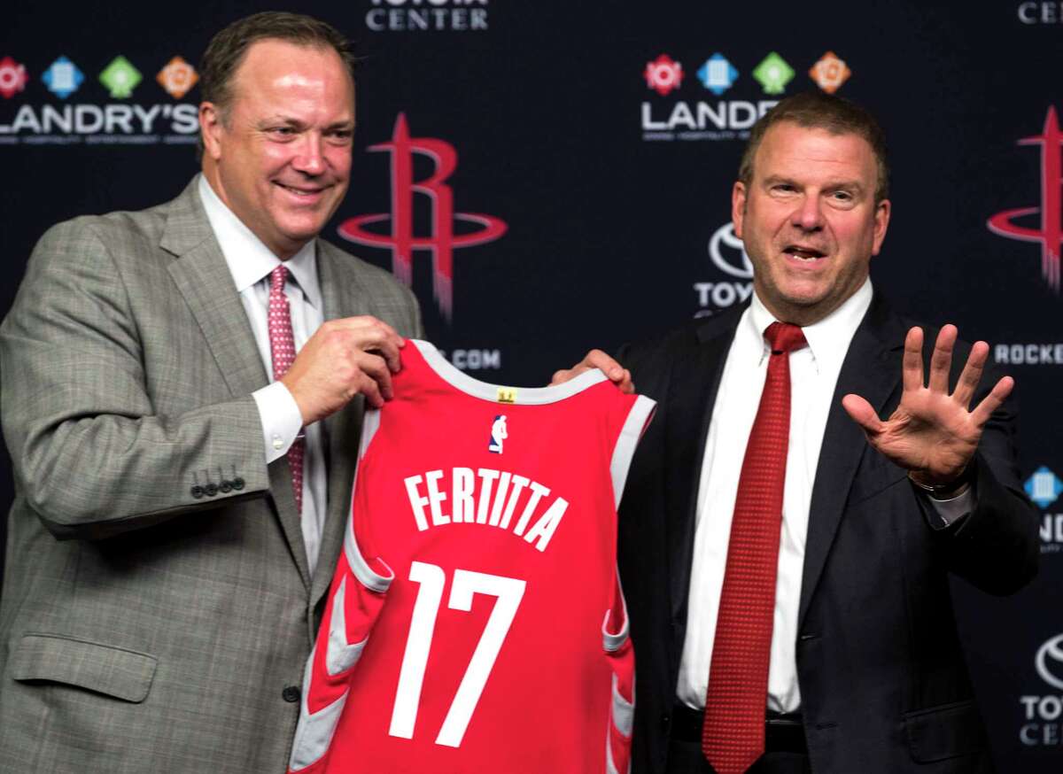 Houston Rockets CEO Tad Brown, left, and new team owner Tilman Fertitta hold up a Rockets jersey during a news conference introducing him as the Rockets new owner at Toyota Center on Tuesday, Oct. 10, 2017, in Houston.