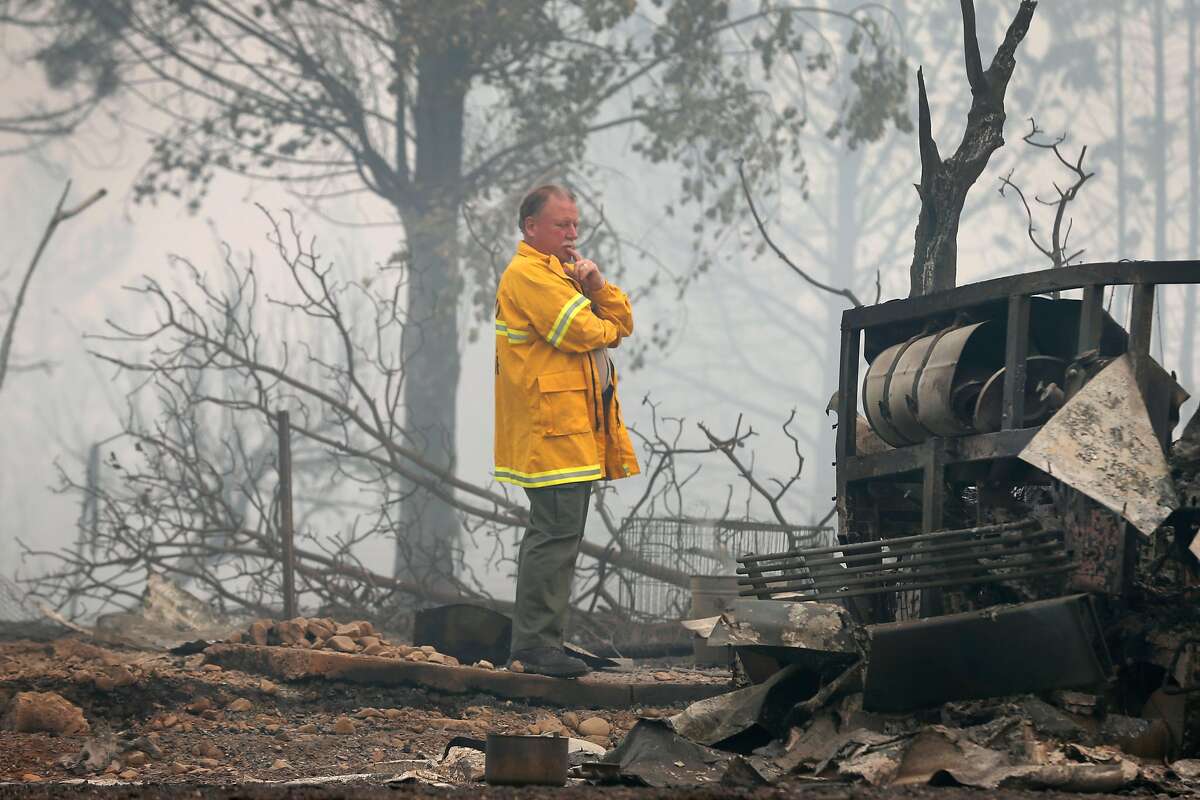 Mendocino Co. Sheriff Tom Allman walks through a home destroyed by fire on Tomki Road in Redwood Valley, Calif. on Tuesday Oct. 10, 2017. Authorities have reported at least three people have died and 50 residences have been destroyed by the Redwood Complex Fire.