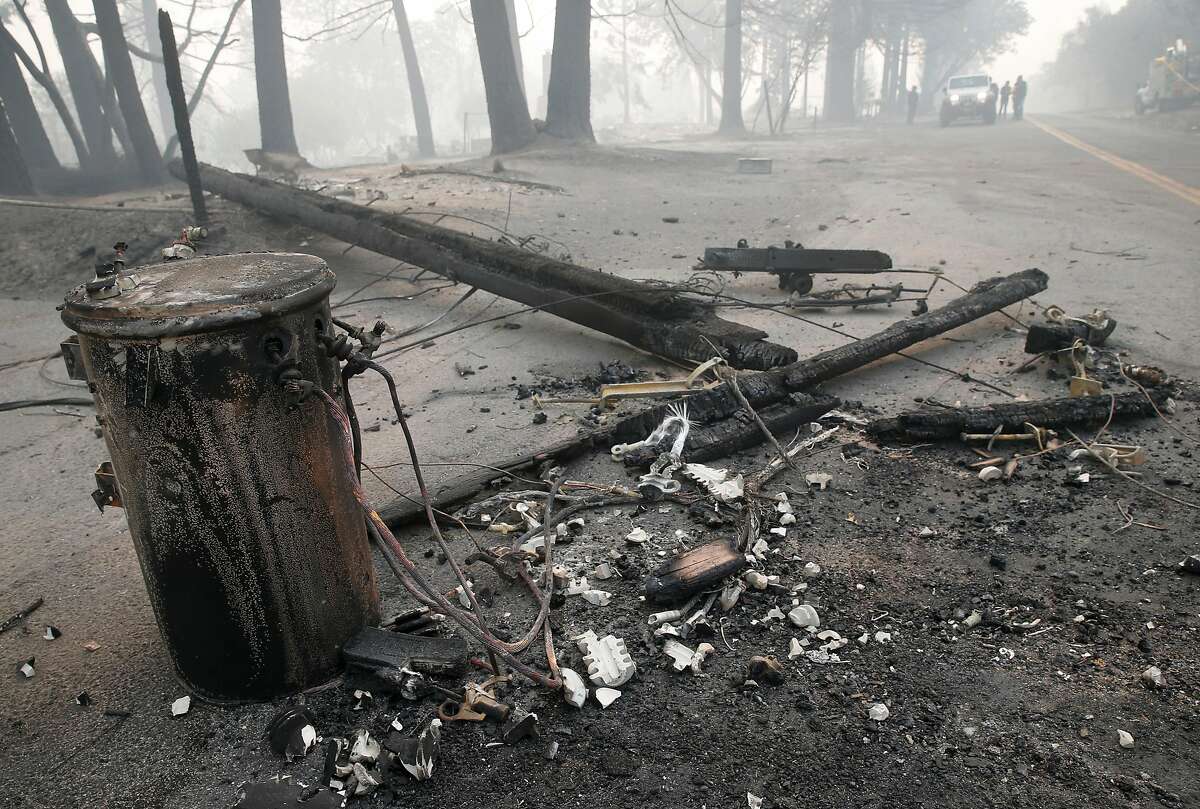 An transformer and utility pole lie in the middle of Tomki Road in Redwood Valley, Calif. on Tuesday Oct. 10, 2017. Authorities have reported at least three people have died and 50 residences have been destroyed by the Redwood Complex Fire.