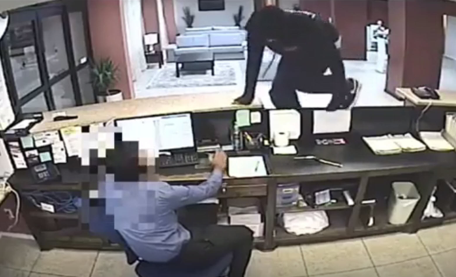 Video: Police search for suspects in hotel assault and robbery