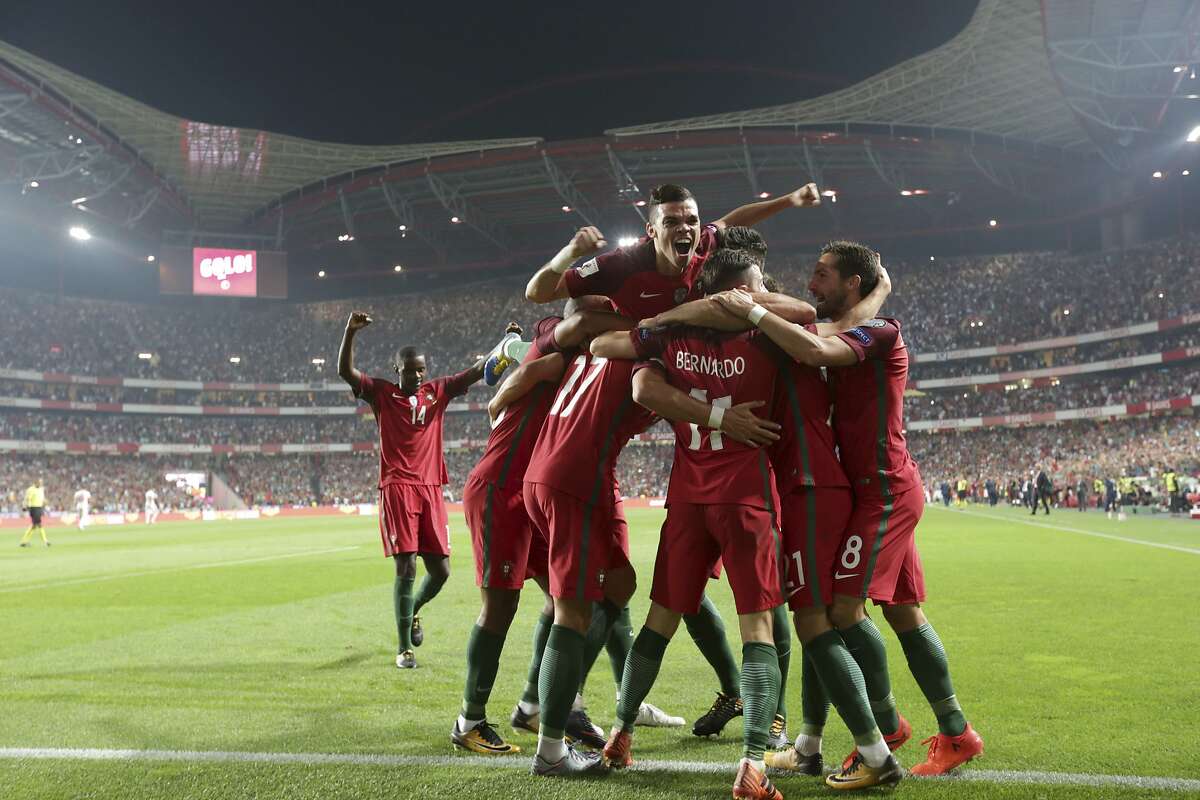 Portugal's Andre Silva celebrates with his teammates after scoring goal during the World Cup Group B qualifying soccer match between Portugal and Switzerland at the Luz stadium in Lisbon, Tuesday, Oct. 10, 2017. (AP Photo/Armando Franca)