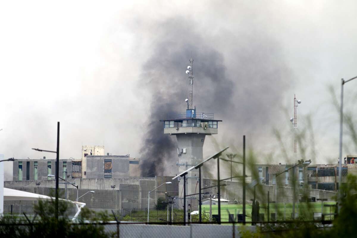 Smoke rises from the Cadereyta prison where a brawl among the prisoners left several wounded on October 10, 2017 in Cadereyta, Nuevo Leon, Mexico. / AFP PHOTO / Julio Cesar AGUILAR (Photo credit should read JULIO CESAR AGUILAR/AFP/Getty Images)