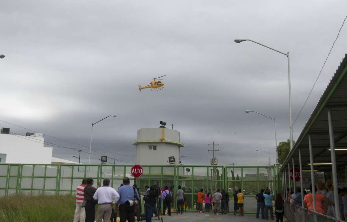 A helicopter overflies the Cadereyta prison where a brawl among the prisoners left several wounded on October 10, 2017 in Cadereyta, Nuevo Leon, Mexico. / AFP PHOTO / Julio Cesar AGUILAR (Photo credit should read JULIO CESAR AGUILAR/AFP/Getty Images)