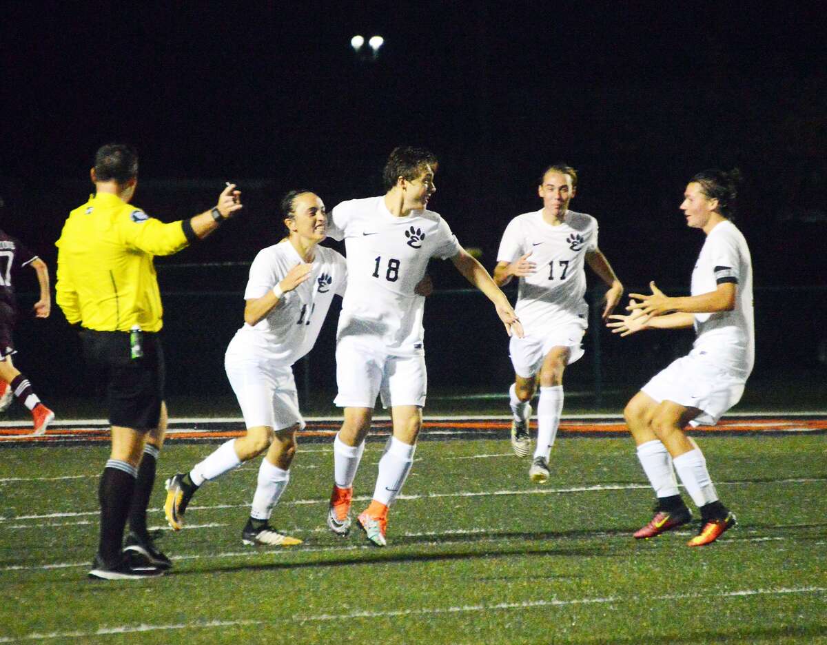 Edwardsville’s Ethan Miracle, left, and Kyle Wright, right, celebrate after Cooper Nolan, center, scores to put the Tigers ahead 2-1 against Belleville West. Bayne Noll (No. 17) is in the background.