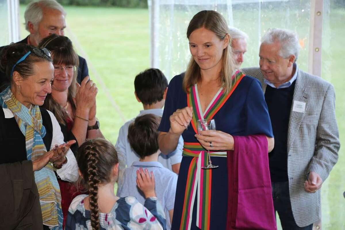 The Kent Land Trust recently held its fall benefit cocktail party at the South Kent home of hosts Katherine Greig, above greeting guests, and David Schwimmer.